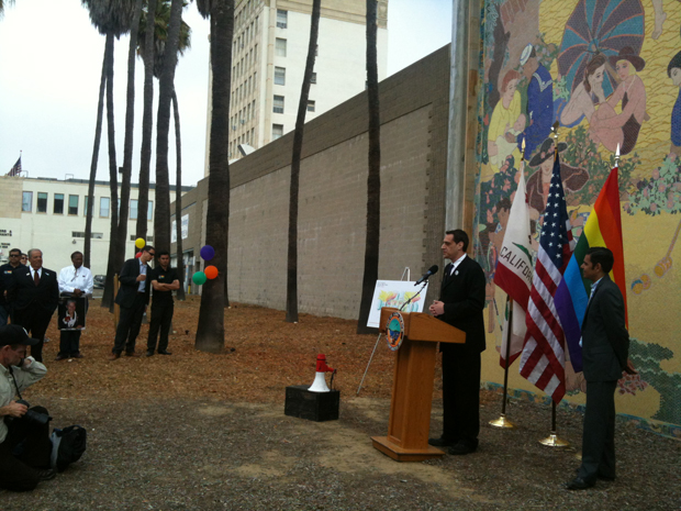 Stuart Milk addresses the crowd, as Councilmember Robert Garcia and Mayor Bob Foster look on