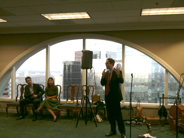Councilmember James Johnson speaking at Friday's fundraiser, as Justin Hectus and Sasha Kanno look on.