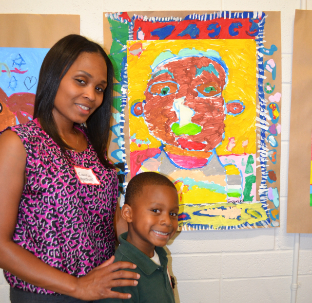 Kindergartner Gavin Hightower (right) poses with his mom Kameron (left) next to his self-portrait.