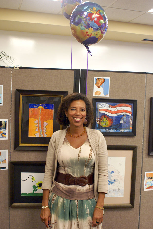 Denise Clayton-Leonard in front of art she helped facilitate