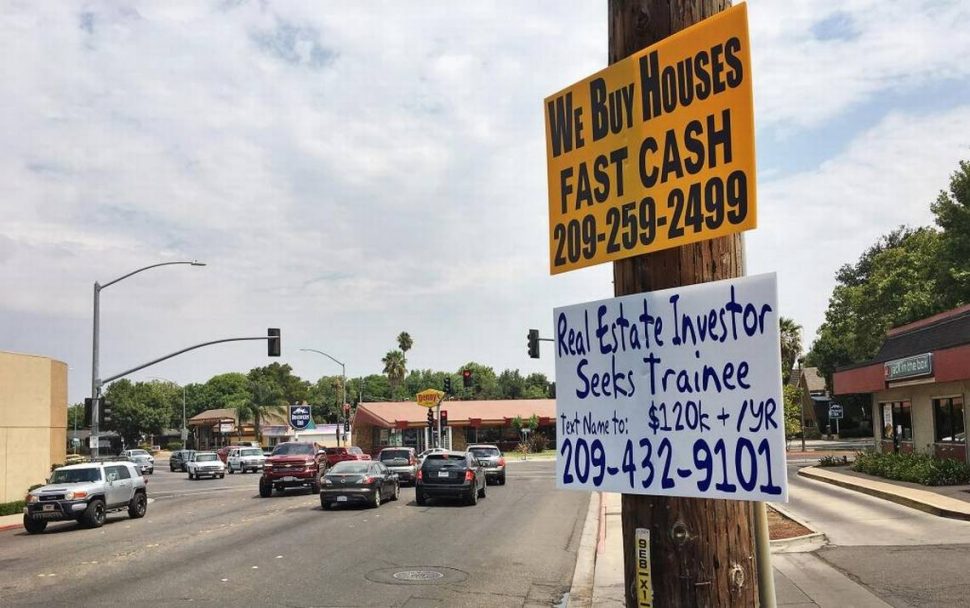 "We Buy Houses in Cash" signs are proliferating across California, drawing in quick sellers with quick buyers. Photo courtesy of Tim Ragsdale/Modesto Bee.