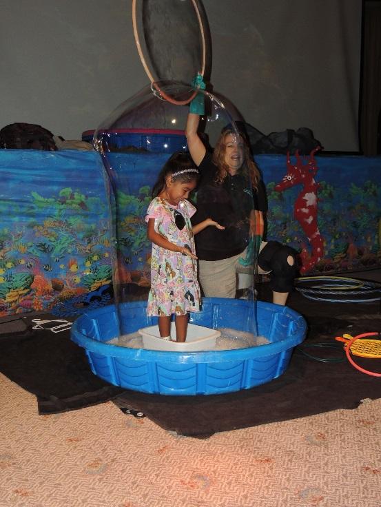 A young patient steps inside a life-size bubble during a beach-themed party at MemorialCare Miller Children’s & Women’s Hospital Long Beach.