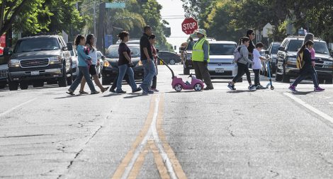 Lorena Gomez crosses parents and school kids safely at Daisy Avenue at 7th Street at Edison Elementary School in Long Beach August 29, 2018. Photo by Thomas R Cordova/Safe Streets