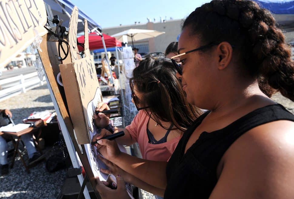 Genesis Valzivia,left, and her friend Amanda Baptist draw charchters during Summer LuvinÕ Fest, at 5301 Long Beach Boulevard in North Long Beach Saturday. The free family friendly event featured multiple bands, as well as vendors, artists and the Long Beach local El Exclusivo food truck on site in Long Beach Saturday, September 1, 2018.<br /> Photo by Stephen Carr / For The Long Beach Post