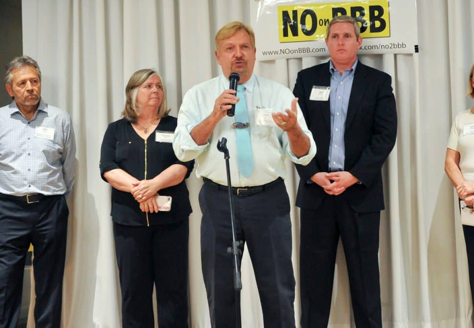 Robert Fox, executive director of the Council of Neighborhood Organizations, stands next to Corliss Lee (left) and Ian Patton (right) at a fundraising event for the anti-charter reform cause at the Long Beach Petroleum Club in Long Beach, Sept. 20, 2018. (John Valenzuela/ Correspondent)