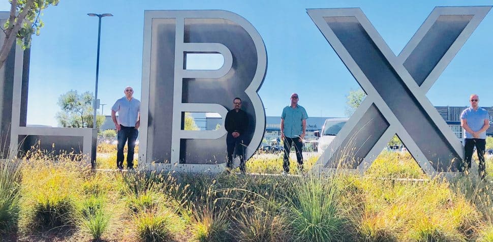 The owners and investors of The 908 restaurant stand in from the LBX logo. Courtesy of Ciaran Gough.