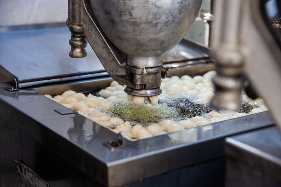 At the Greek Fest, dough squishes into oil to be made into Greek Donuts in Long Beach Sunday September 2, 2018. Photo by Kelly Smiley