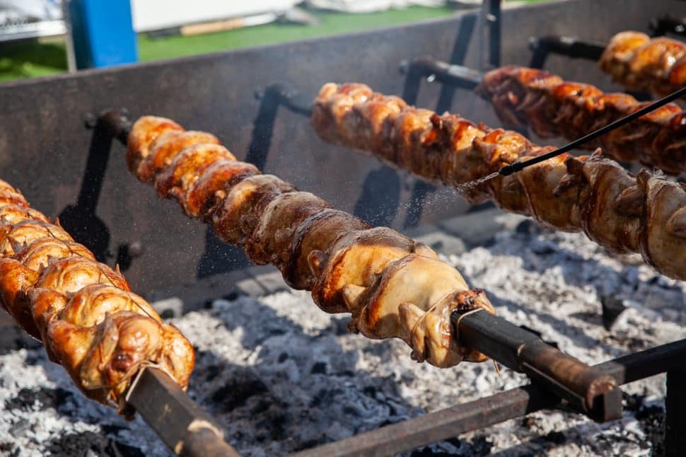 George Rivera bastes chickens with a mixture of lemon juice, olive oil and oregano to keep them hydrated and fresh at the Greek Fest in Long Beach Sunday September 2, 2018. Photo by Kelly Smiley