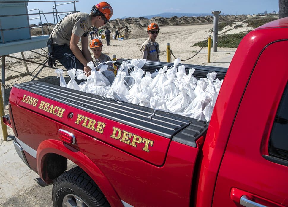 Long Beach Fire Department Search and Rescue members load sandbags in hopes of protecting homes as crews rebuild the sand berm on the Peninsula In Long Beach October 5, 2018. Photo by Thomas R Cordova.
