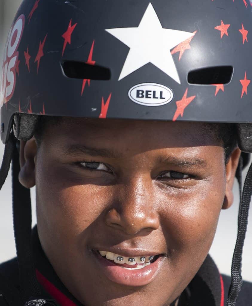 Jassiah Smith,14 of Long Beach, with his new bike helmet after the Long Beach police took a collecting to replace his bike after it was stolen over the weekend in Long Beach October 23, 2018. Photo by Thomas R Cordova.