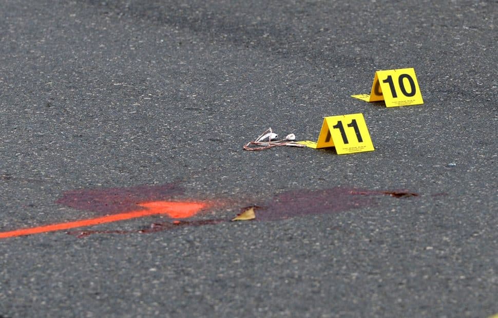 Long Beach Police marked a blood spot and ear buds at the scene of an crash, where a skateboarder was struck by a vehicle at the intersection of Bellflower Boulevard and 27th Street on Tuesday, Nov. 27, 2018. Photo by Stephen Carr.